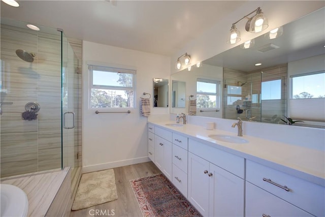 2510 Terrace Sands Ln, Oceano, CA 93445 - full bathroom featuring a stall shower, a sink, wood finished floors, and plenty of natural light
