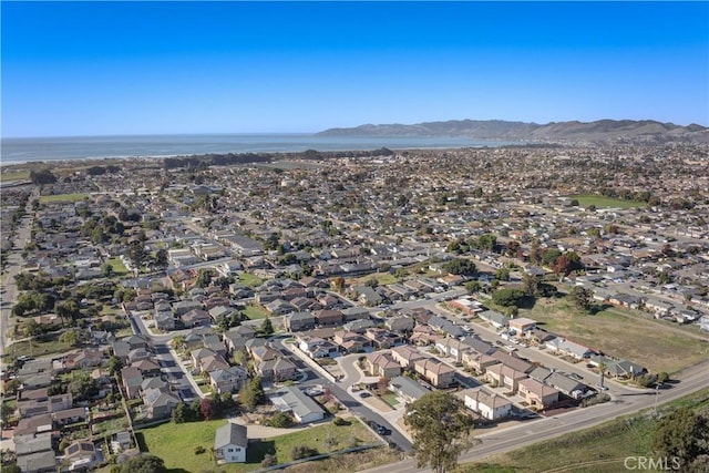 drone / aerial view featuring a water and mountain view