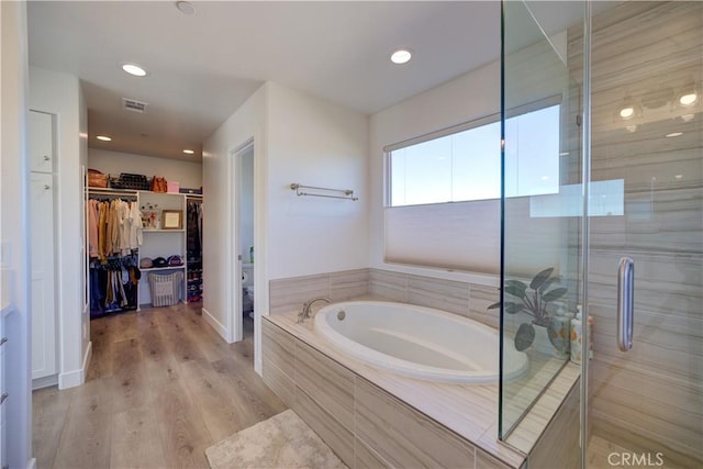 2510 Terrace Sands Ln, Oceano, CA 93445 - bathroom with visible vents, a garden tub, a stall shower, wood finished floors, and a walk in closet