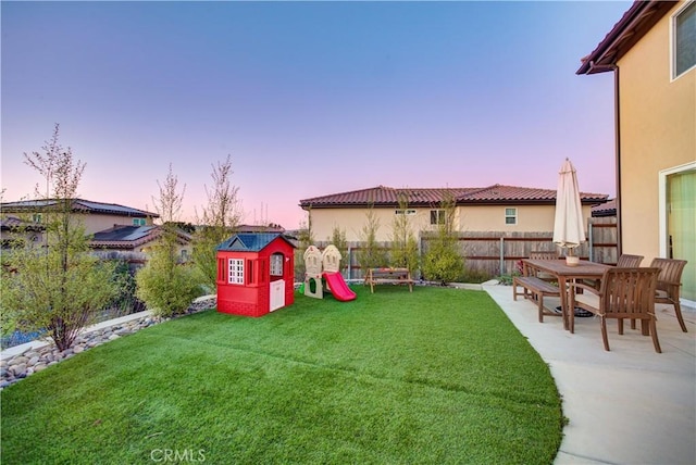 yard at dusk with a patio