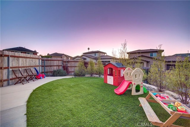 2510 Terrace Sands Ln, Oceano, CA 93445 - playground at dusk with a lawn, a fenced backyard, and a playground