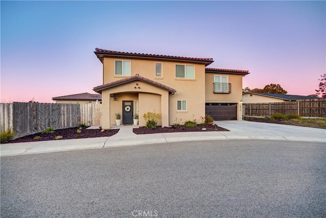 mediterranean / spanish home with a garage