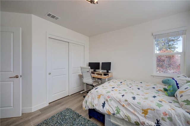 bedroom featuring a closet and light hardwood / wood-style flooring