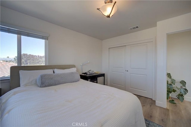 bedroom featuring hardwood / wood-style floors and a closet