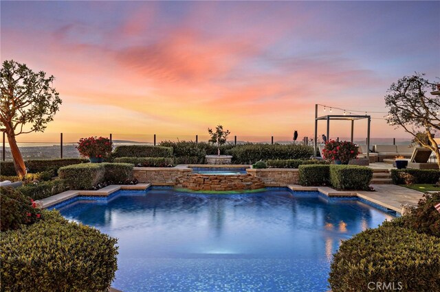 view of pool at dusk