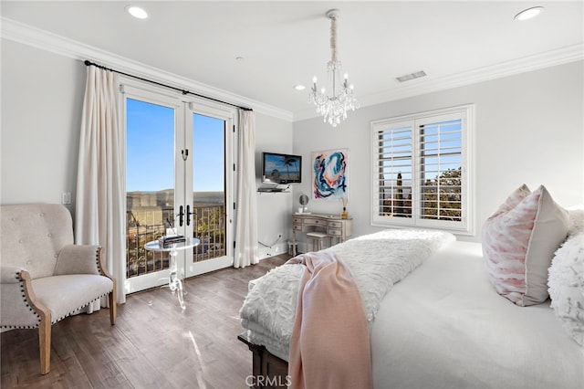 bedroom with access to outside, wood finished floors, visible vents, and crown molding