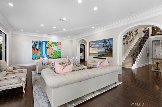 living room with arched walkways, crown molding, recessed lighting, visible vents, and wood finished floors