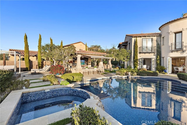 view of pool featuring a pool with connected hot tub and a patio area