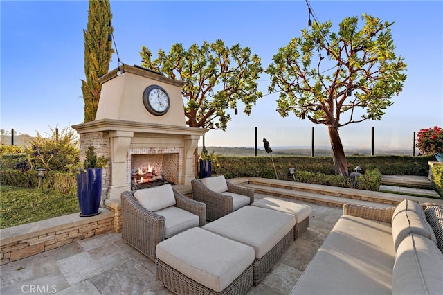 view of patio / terrace with an outdoor living space with a fireplace