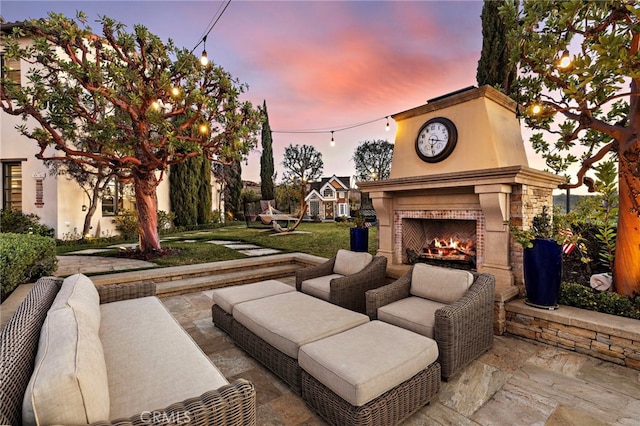 view of patio featuring an outdoor living space with a fireplace