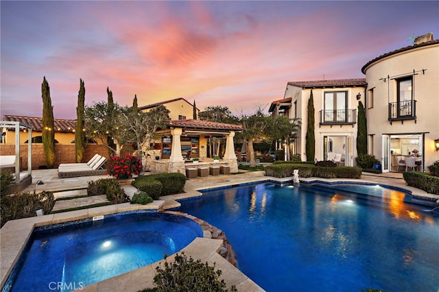 view of pool with a patio area and a pool with connected hot tub