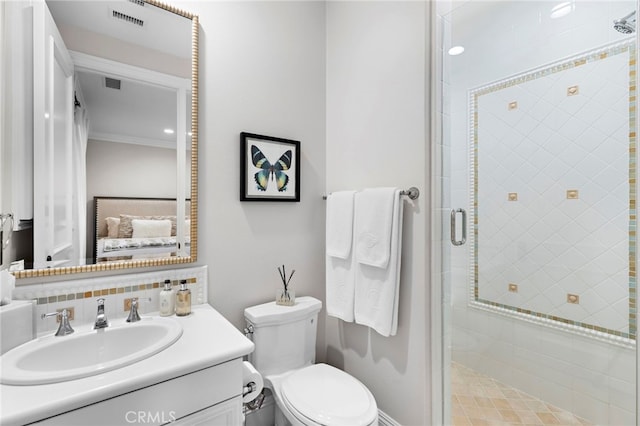 bathroom with crown molding, visible vents, toilet, a shower stall, and vanity