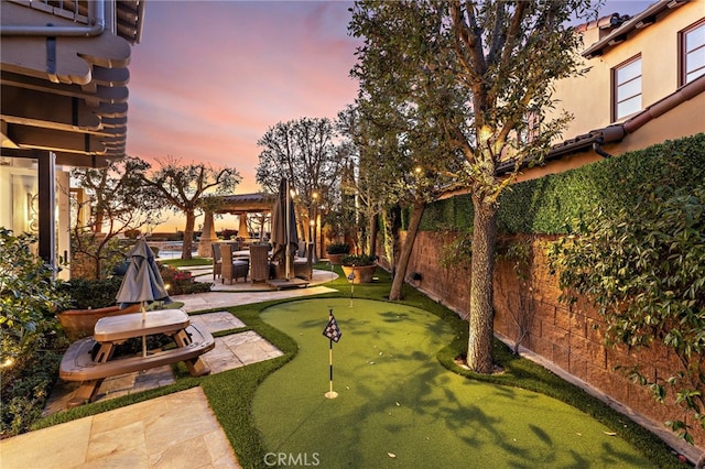 view of yard with a patio area, a fenced backyard, and a pergola