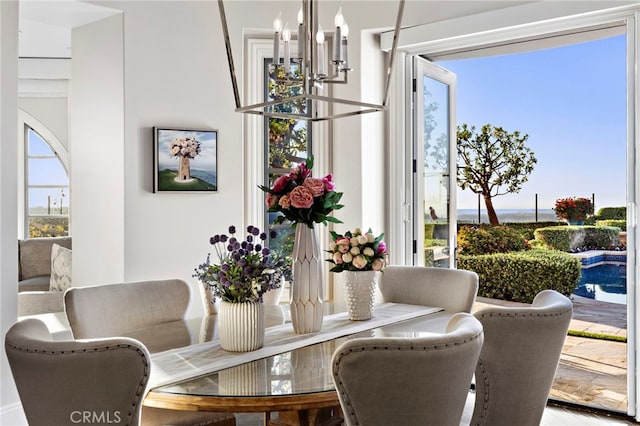 dining area featuring plenty of natural light and an inviting chandelier