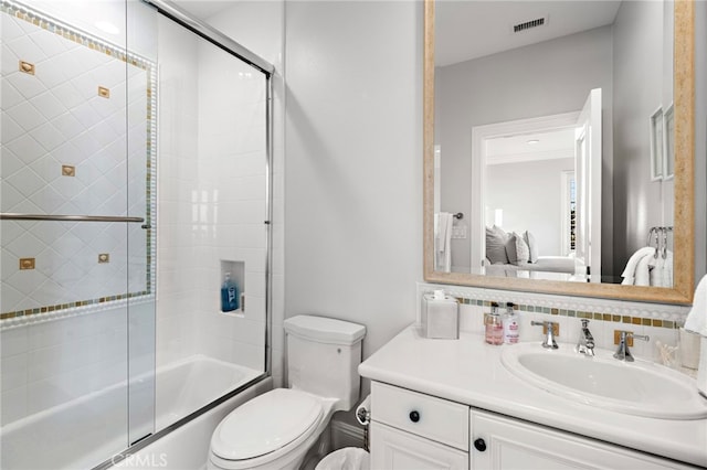 ensuite bathroom with bath / shower combo with glass door, visible vents, backsplash, toilet, and vanity