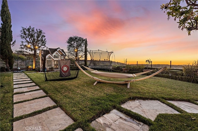 playground at dusk featuring playground community and a lawn