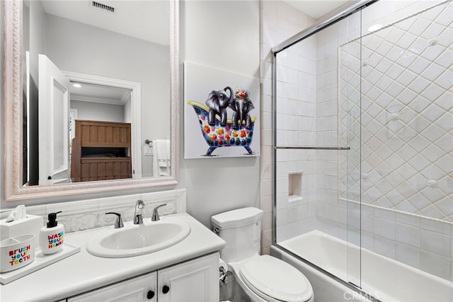 full bathroom featuring toilet, enclosed tub / shower combo, visible vents, and vanity