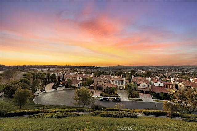 aerial view at dusk featuring a residential view