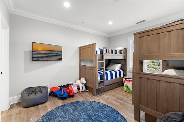 bedroom featuring crown molding, light wood finished floors, recessed lighting, visible vents, and baseboards