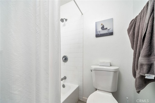 bathroom featuring toilet and tiled shower / bath