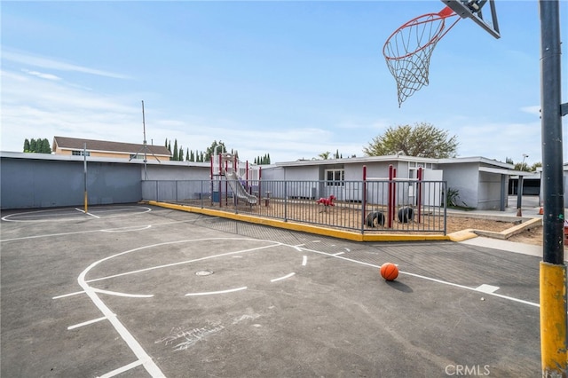 view of sport court featuring a playground