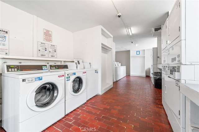 laundry room with stacked washer / dryer and washer and clothes dryer