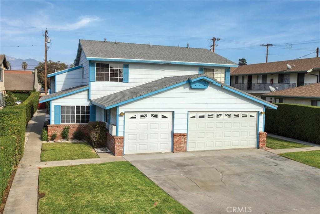 front facade featuring a garage and a front yard