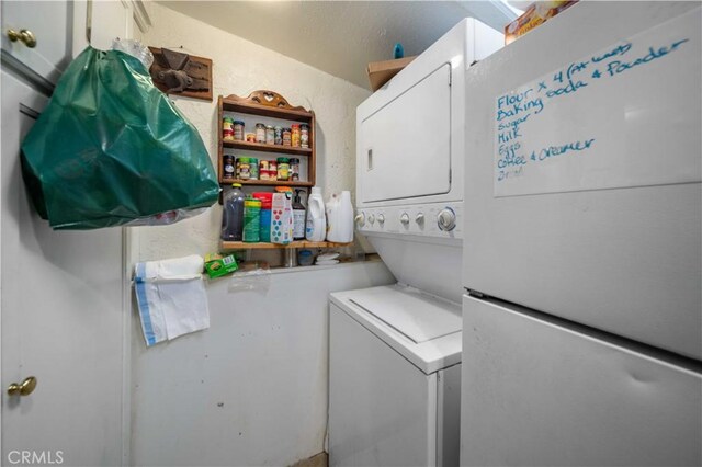 laundry room with stacked washer and clothes dryer