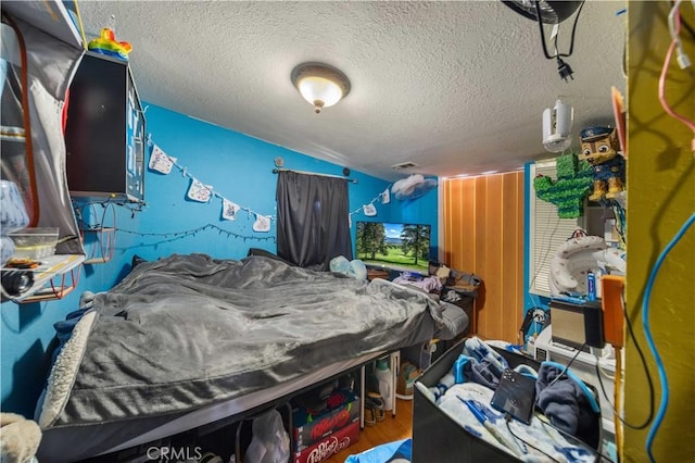 bedroom featuring a textured ceiling and hardwood / wood-style floors