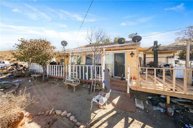 back of property featuring a wooden deck