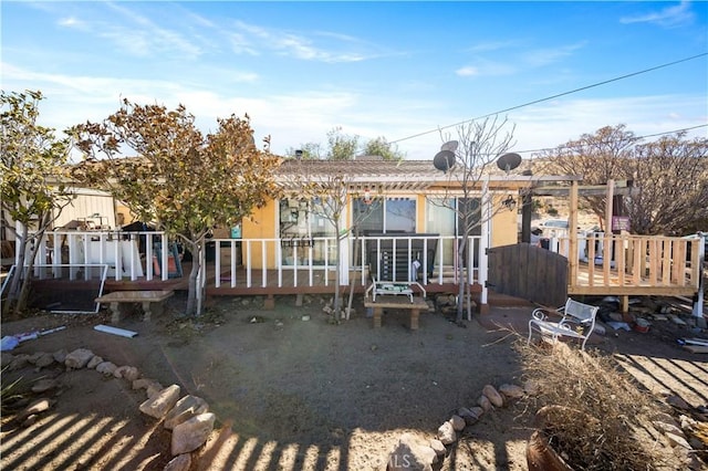 back of house with a wooden deck