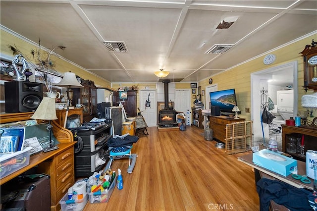 interior space with a wood stove and light hardwood / wood-style flooring