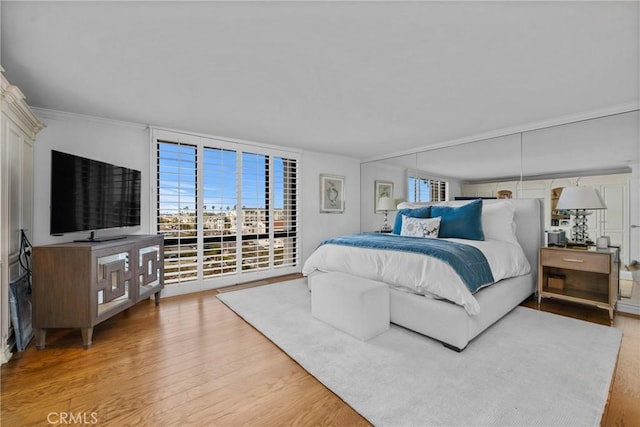 bedroom featuring light hardwood / wood-style flooring and access to outside