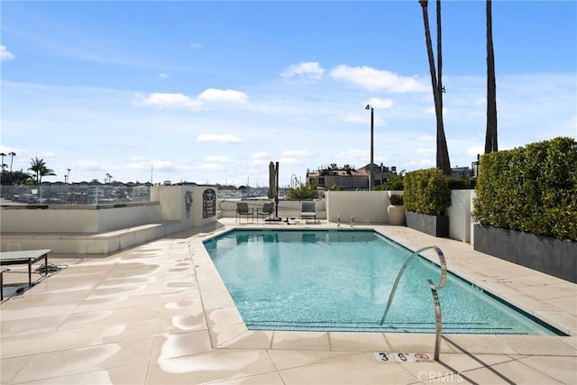 view of swimming pool featuring a patio area