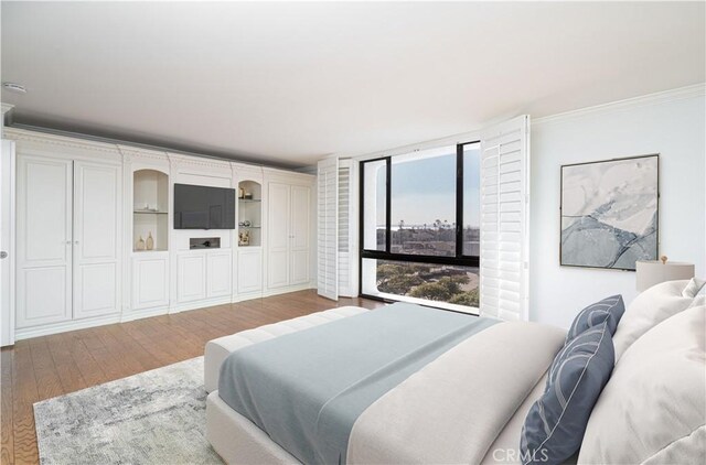 bedroom featuring floor to ceiling windows and hardwood / wood-style floors