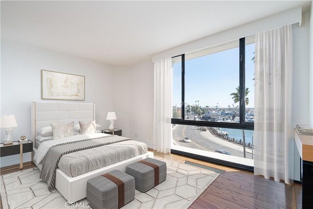 bedroom featuring baseboards and wood finished floors