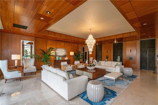 living area with a raised ceiling, wood ceiling, wood walls, and an inviting chandelier