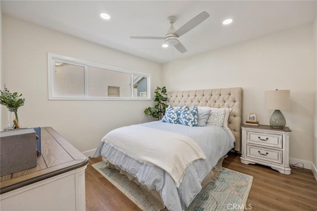 bedroom featuring ceiling fan and dark hardwood / wood-style floors