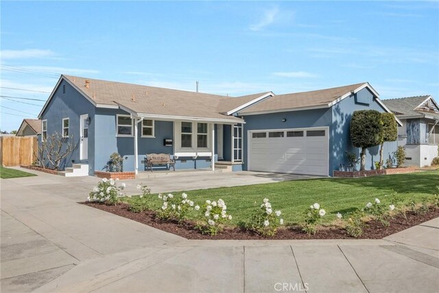 ranch-style house with a garage and a front yard