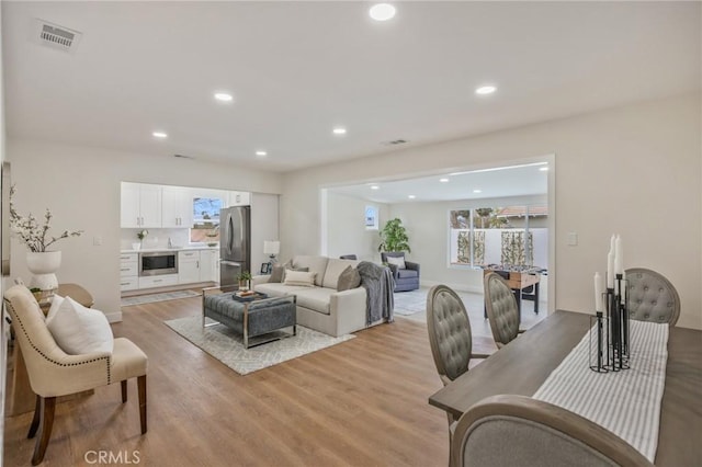 living room with light hardwood / wood-style flooring