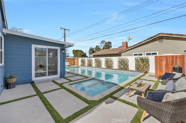 view of pool featuring a patio area, central AC unit, and an in ground hot tub