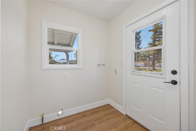 doorway with hardwood / wood-style flooring