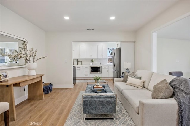 living room with light hardwood / wood-style floors