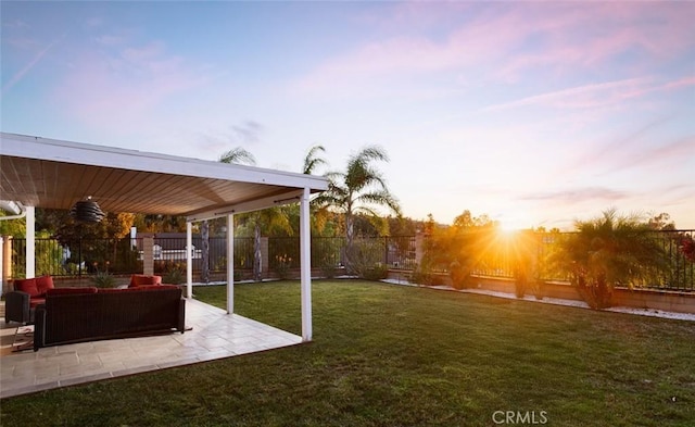 yard at dusk featuring an outdoor hangout area and a patio area