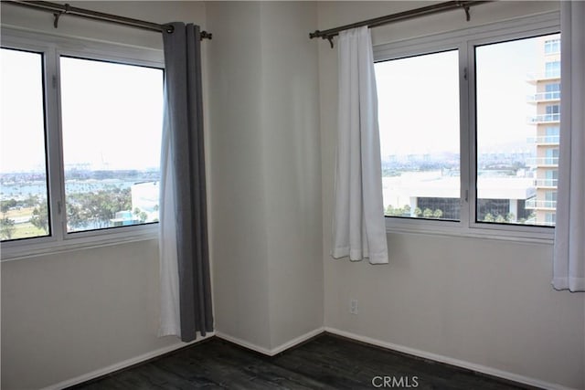 525 E Seaside Way Unit 1504, Long Beach, CA 90802 - spare room featuring healthy amount of natural light, dark wood finished floors, and a view of city