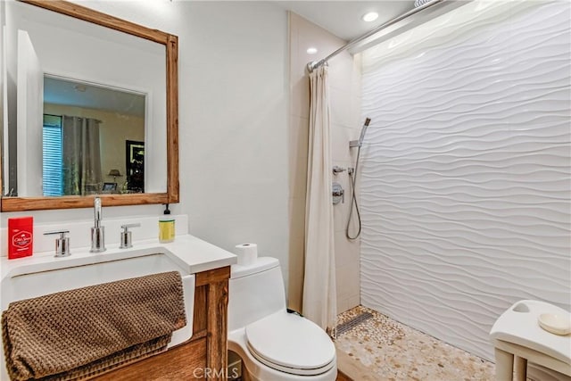 bathroom with toilet, a shower with shower curtain, and vanity