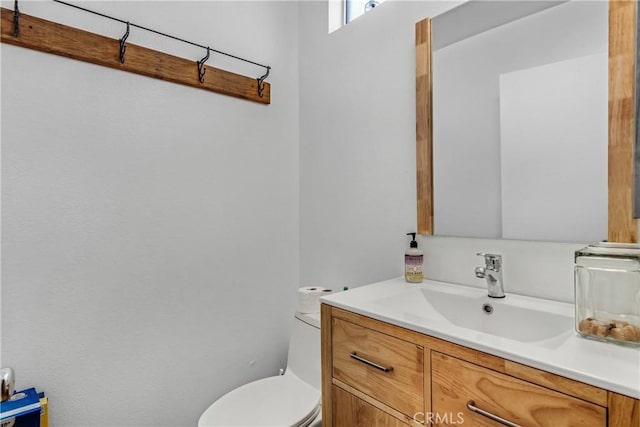 bathroom featuring toilet and vanity