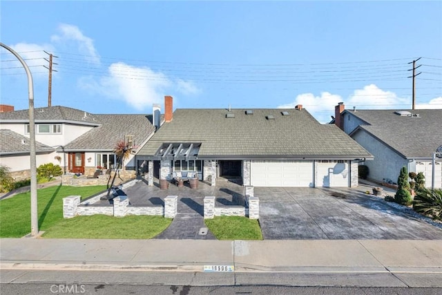 view of front of house with a front yard and a garage