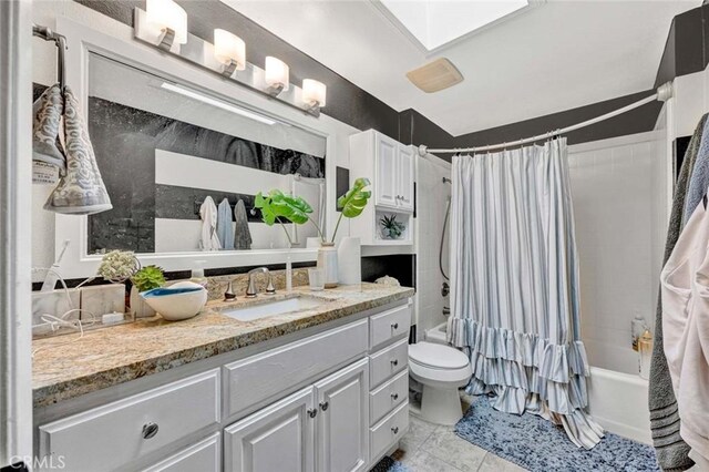 full bathroom with toilet, a skylight, tile patterned floors, vanity, and shower / bathtub combination with curtain