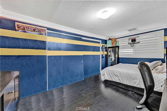 bedroom with a textured ceiling and ornamental molding